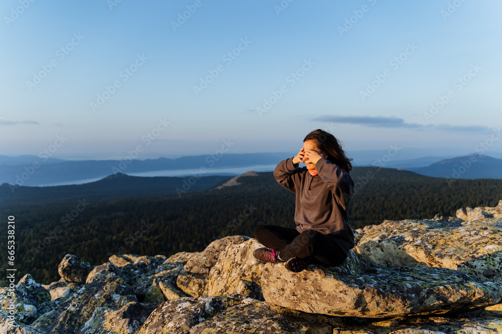 Unity with nature, meditation at dawn, mountain kingdom, girl sitting in lotus position meditating, yoga in nature, mountain landscape, man in practice. Unity with nature, meditation at dawn, mountain kingdom, girl sitting in lotus position meditating, yoga in nature, mountain landscape, man in practice.