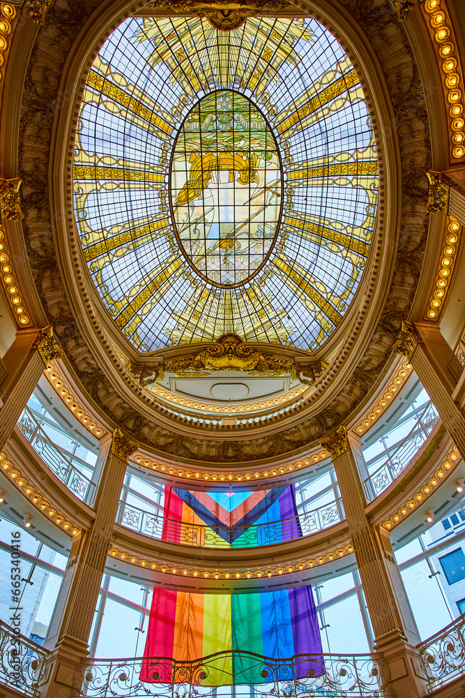 Rainbow flag dangling from Rotunda Roof interior view with stained glass ceiling