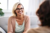 female psychologist with glasses smiling at a meeting with a patient client