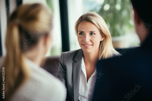 happy smiling blond business woman manager at office meeting with client at work