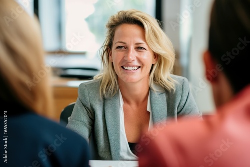 smiling female manager interviewing new applicants in office