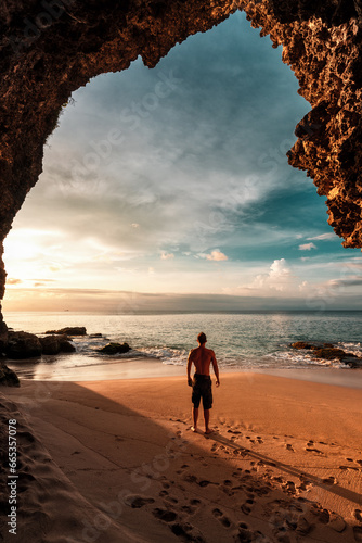 Amazing view from mountain cave on coastline tropical beach with silhouette travel people on background nature landscape