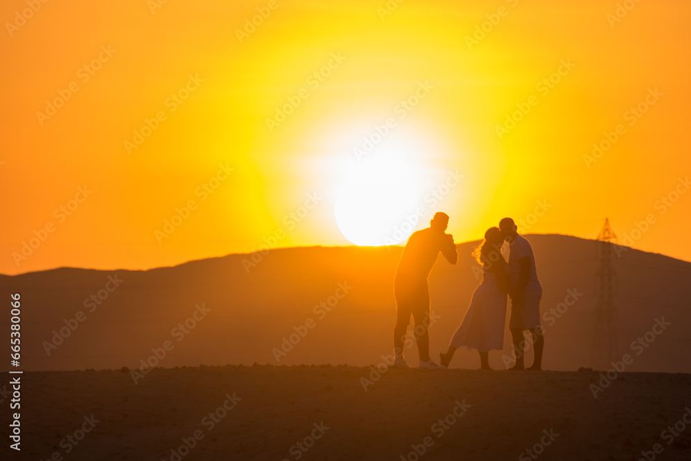 photoshooting during sunset from a couple in the desert