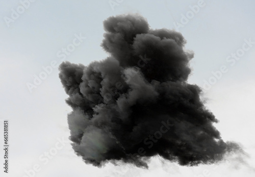 black cloud of thick of very dark smoke in the sky after the explosion