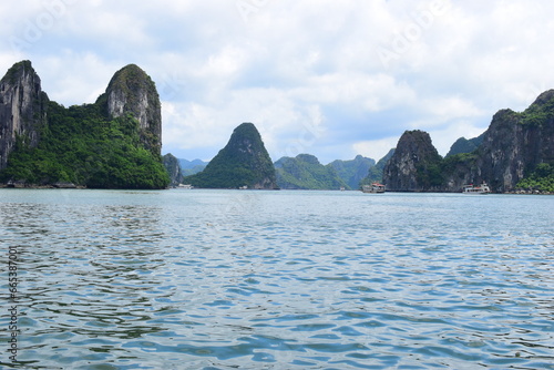HA LONG BAY, VIETNAM - JULY 19, 2022: Beautiful view of the Halong bay, Vietnam. UNESCO World Heritage. This was on a cloudy day, with many boats and spells of sunshine. during the Covid 19 pandemic. 