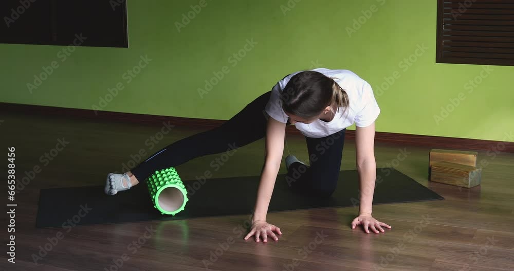 A woman leading a healthy lifestyle massages her leg muscles with a ...