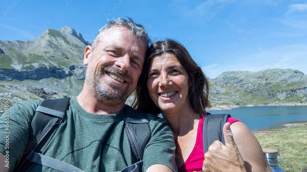 cheerful middle aged happy couple taking selfie in mountain spain vacation