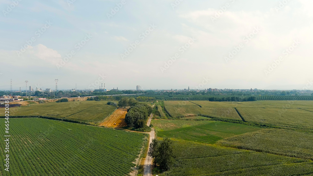 Piacenza, Italy. Flight towards the city over the fields. Po River, Aerial View