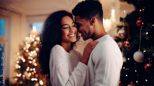 Happy young interracial married couple at christmas celebration. Christmas tree with a luminous garland in the background. Ai generated