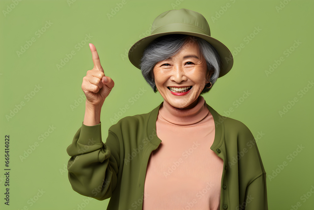 Senior woman wear green clothes winter style happy greeting on pastel background Senior woman wear green clothes winter style happy greeting on pastel background