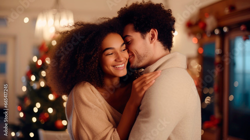 Happy young interracial married couple at christmas celebration. Christmas tree with a luminous garland in the background. Ai generated © millenius