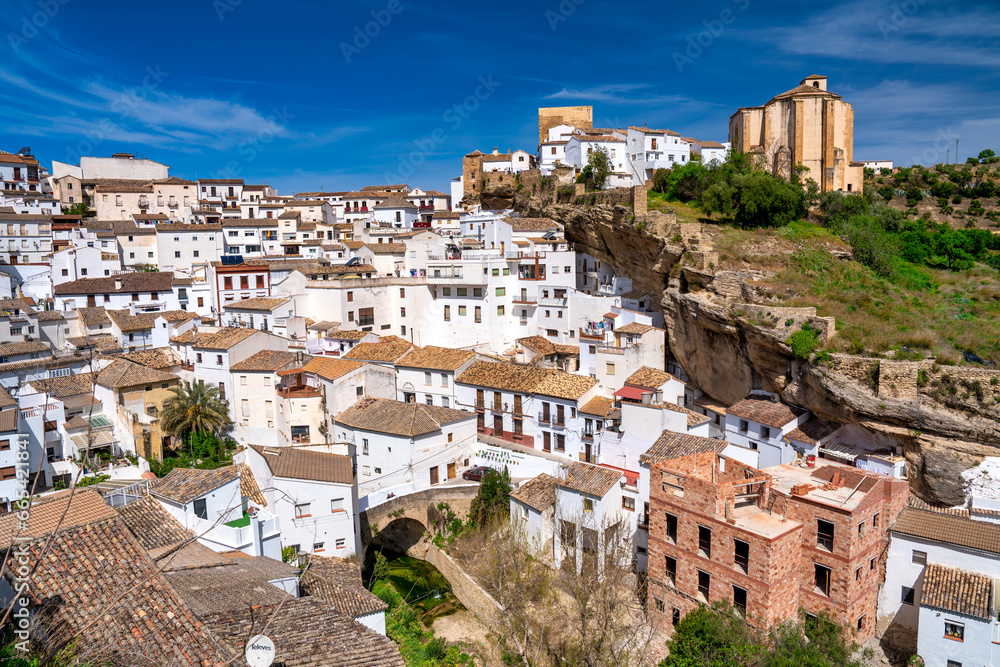 Setenil de las Bodegas. Typical Andalucian village with white houses and sreets with dwellings built into rock overhangs above Rio Trejo
