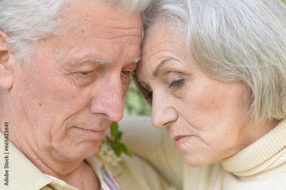 Portrait of sad senior couple in the park Portrait of sad senior couple in the park