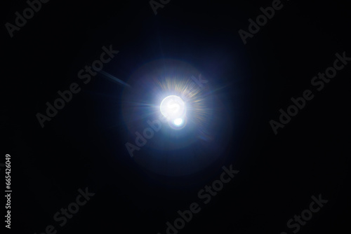 Easy to add lens flare effects for overlay designs or screen blending mode to make high-quality images. Abstract sun burst, digital flare, iridescent glare over black background.