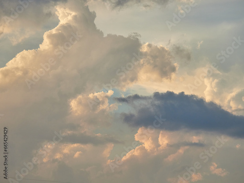 Beautiful clouds at sunset. Cumulus clouds on the background of the sunset sky.
