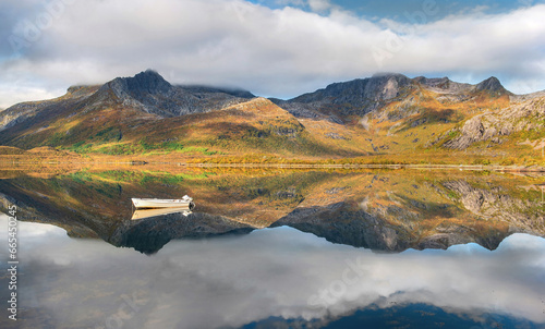 wonderful mountainous landscape in Norway reflected on the water surface with...