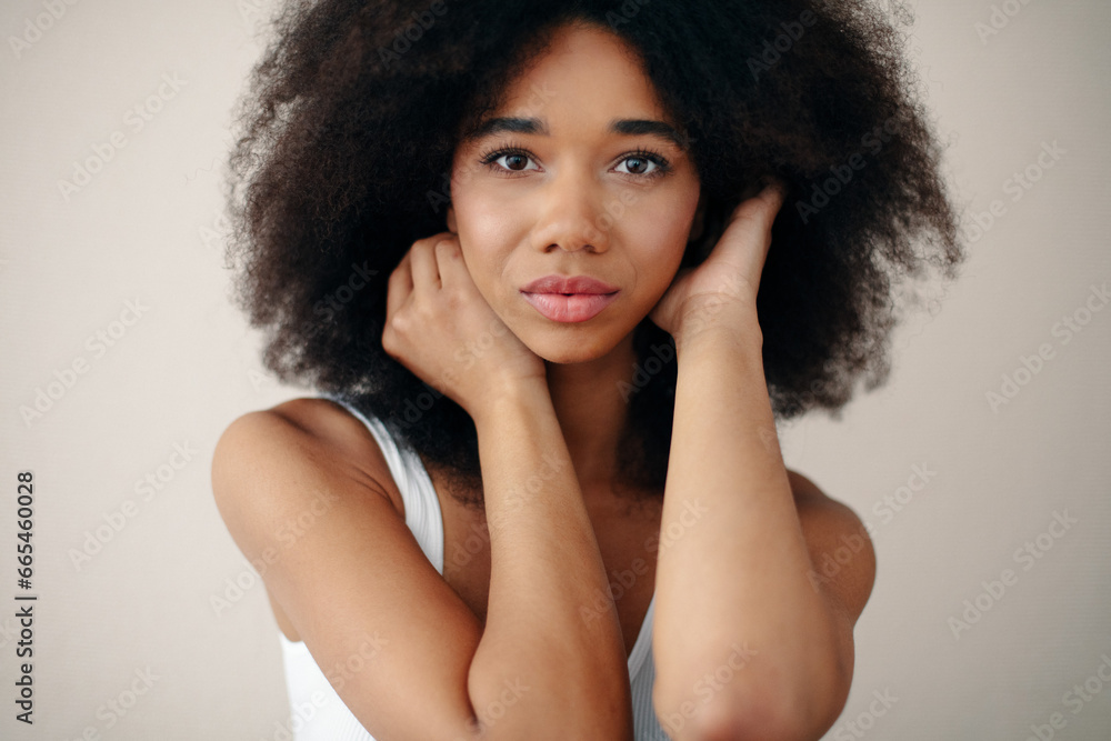 Portrait of Beautiful Young Woman Posing In Studio Over Beige Background. Portrait of Beautiful Young Woman Posing In Studio Over Beige Background.