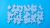 Components of a jigsaw puzzle on a blue