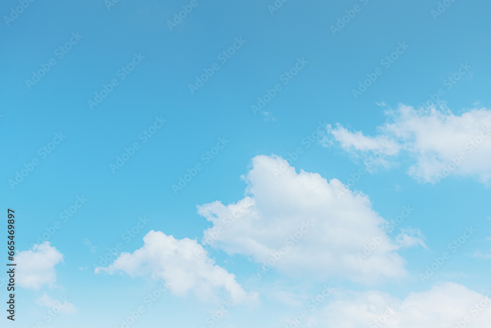 Blue sky and white clouds float in the sky on a clear day with warm sunlight. The sky was clear in the calm sunshine. Bright winter weather background. Blue sky and white clouds float in the sky on a clear day with warm sunlight. The sky was clear in the calm sunshine. Bright winter weather background.
