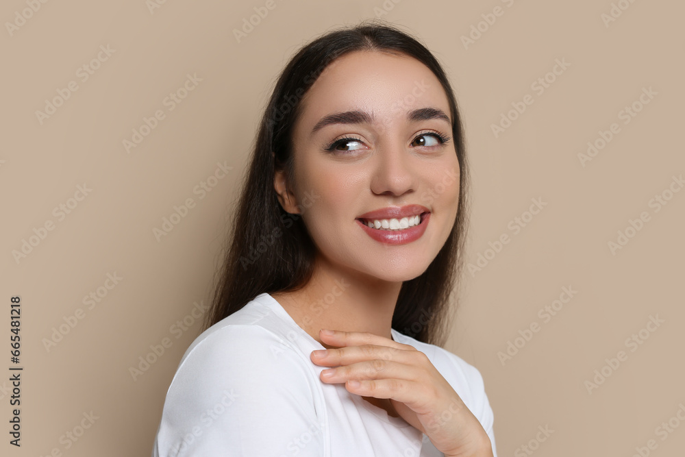 Portrait of beautiful young woman with elegant makeup on dark beige background Portrait of beautiful young woman with elegant makeup on dark beige background