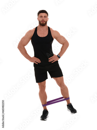 Young man exercising with elastic resistance band on white background © New Africa