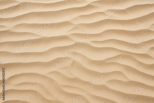 Closeup of sand pattern of a beach in the summer. © MdBepul