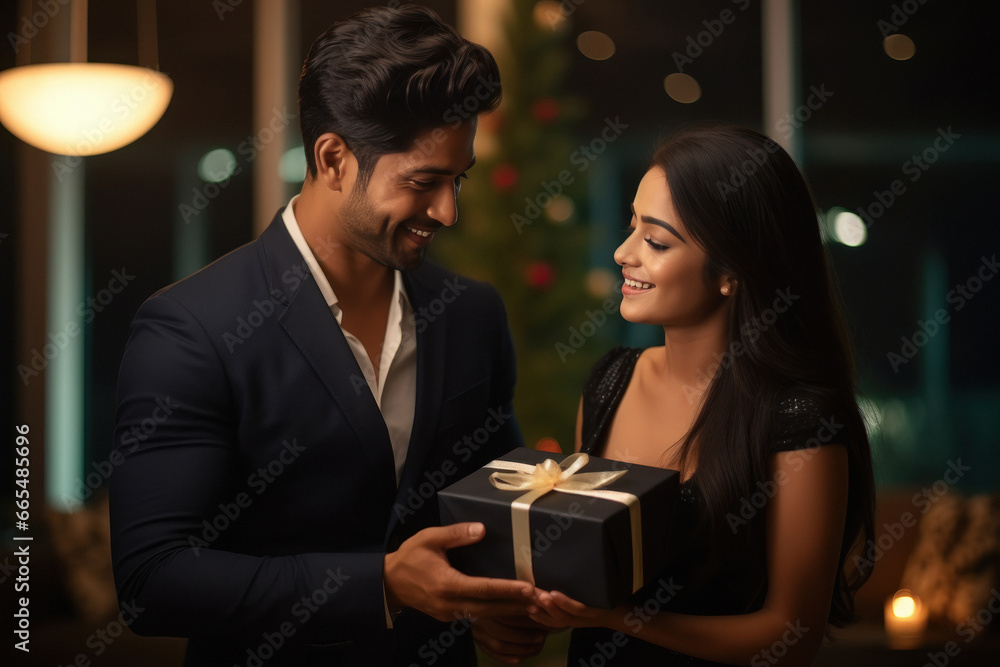 young man giving a gift to his wife or girlfriend. young man giving a gift to his wife or girlfriend.