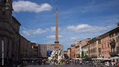 Rome, Italy - 5 September 2023. Piazza Navona with 17th century Obelisco Agonale and Fountain of Four Rivers - Nile, Danube, Ganges, Rio de la Plata on sunny day, sightseeing tourists walking around. photo