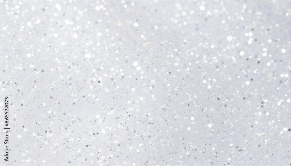 White texture scattered with small silver glitter particles of varying sizes and shapes.