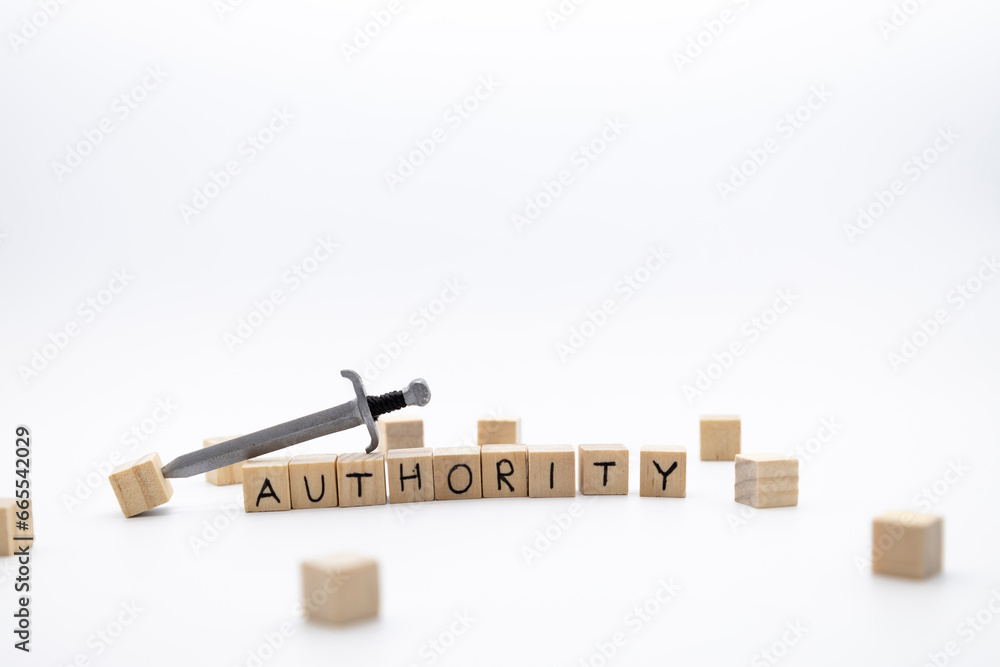The wooden cubes with the word AUTHORITY and the weapon around against white background. The wooden cubes with the word AUTHORITY and the weapon around against white background.