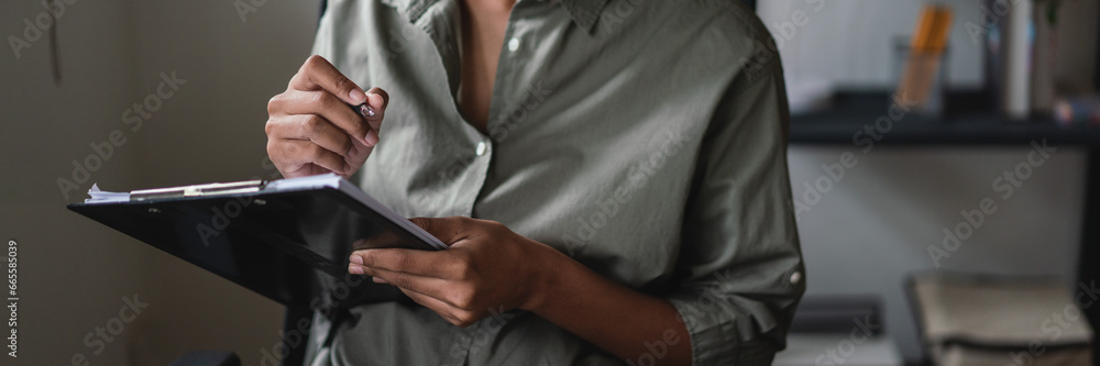 African american businesswoman thinking about strategy of new business and writing data in paper African american businesswoman thinking about strategy of new business and writing data in paper