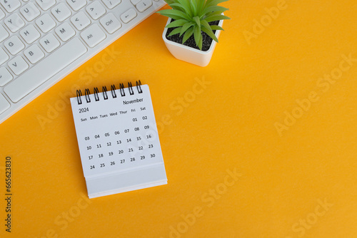 November 2024 desk calendar on yellow background. Directly above. Flat lay.