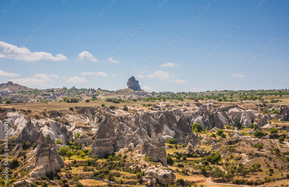 Rocky landscape in Cappadocia, Turkey. Travel in Cappadocia. Unusual semi-desert mountain ranges. Amazing Rocky summer landscape in Cappadocia Goreme