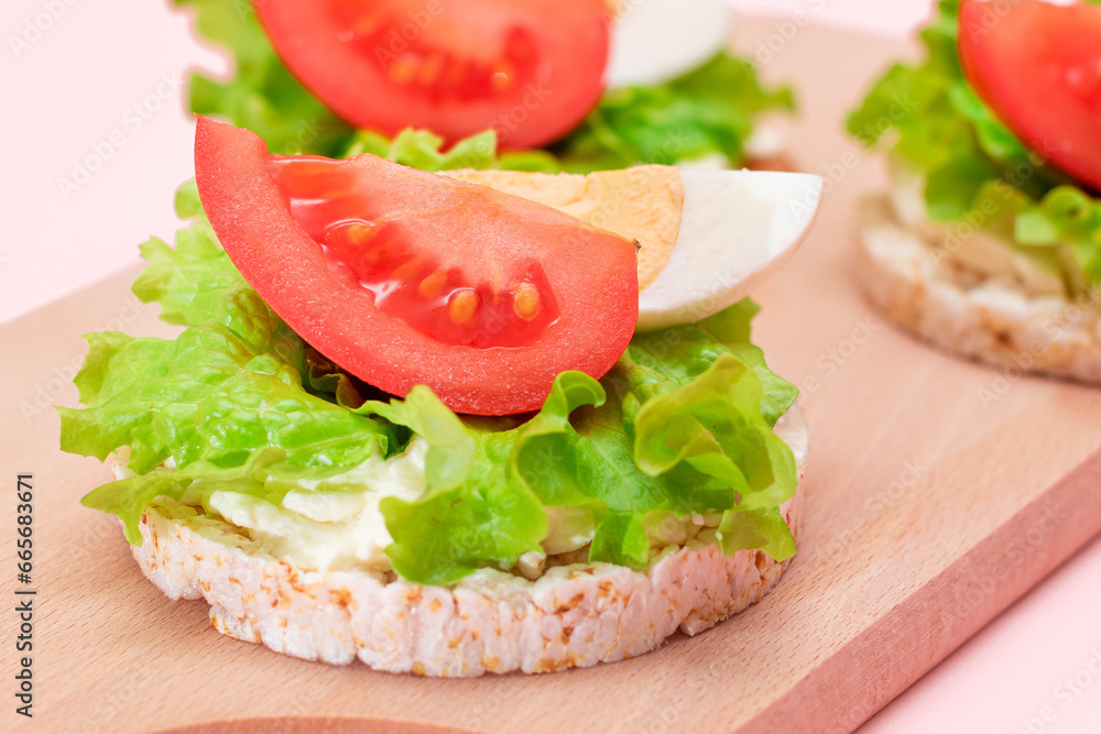 Rice Cake Sandwiches with Tomato, Lettuce and Egg on Wooden Cutting Board. Easy Breakfast. Diet Food. Quick and Healthy Sandwiches. Crispbread with Tasty Filling. Healthy Dietary Snack Rice Cake Sandwiches with Tomato, Lettuce and Egg on Wooden Cutting Board. Easy Breakfast. Diet Food. Quick and Healthy Sandwiches. Crispbread with Tasty Filling. Healthy Dietary Snack