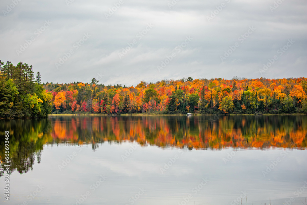 Colorful autumn trees on lake of the Falls in Mercer, Wisconsin