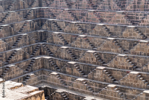 View of Chand Baori stepwell situated in the village of Abhaneri in the Indian state of Rajasthan. It is one of the deepest and largest stepwells in India photo