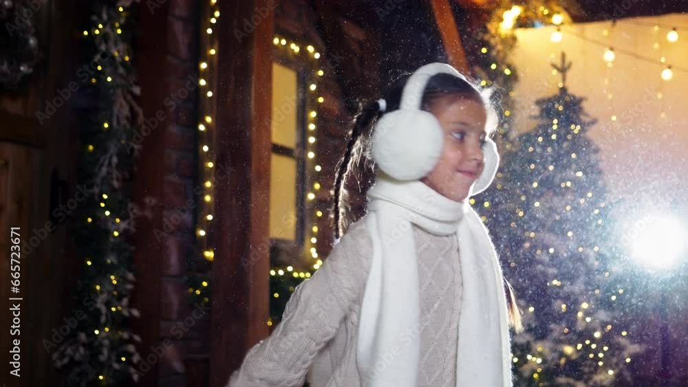 Happy child girl spinning under magical lovely snow fall, enjoy carefree winter walk and holiday dreams. Kid joy, festive miracle and Christmas spirit Happy child girl spinning under magical lovely snow fall, enjoy carefree winter walk and holiday dreams. Kid joy, festive miracle and Christmas spirit