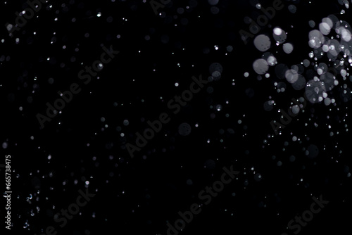 Fototapeta Naklejka Na Ścianę i Meble -  small drops of rain, snow on a black background. wind. Natural background