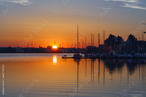 Sunrise at the Harbor of Rostock, Baltic sea, Germany, beautiful scenery with orange sky
