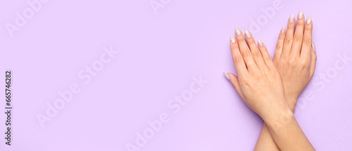 Female hands with beautiful manicure on lilac background with space for text
