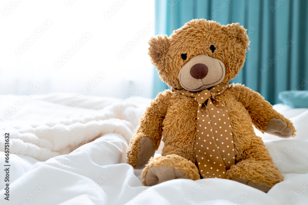 Teddy bear toy sitting on bed empty copy space. Maternity concept.Childhood.