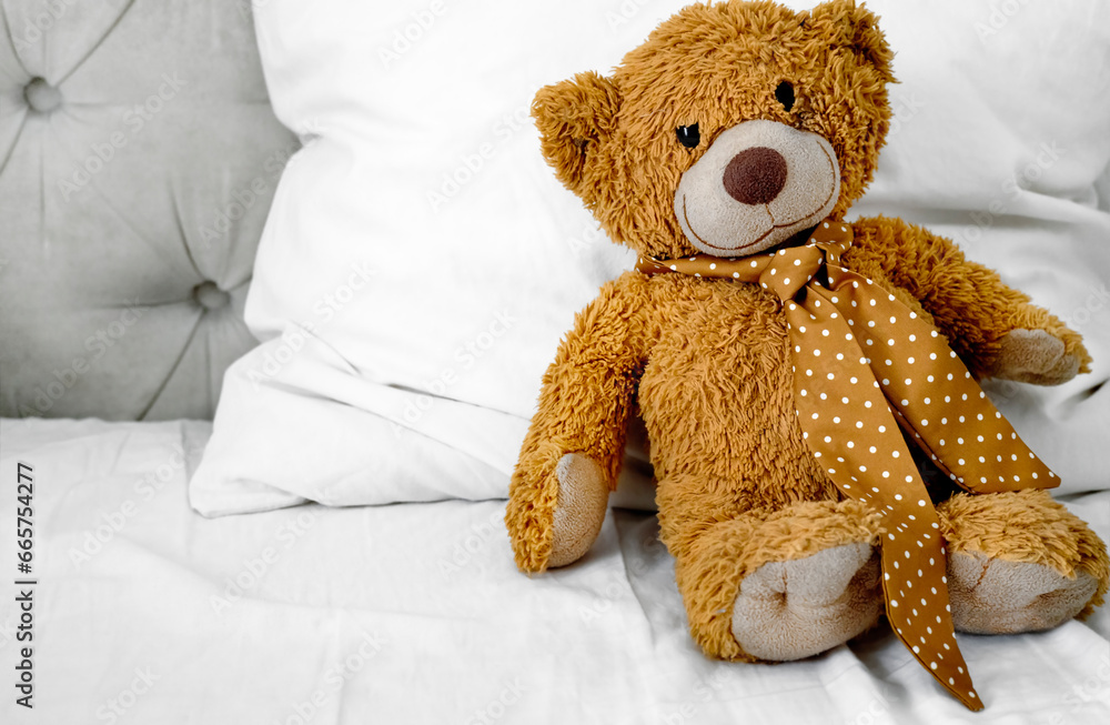 Teddy bear  sitting in bed empty copy space. Maternity concept.Childhood. Child's bedroom.