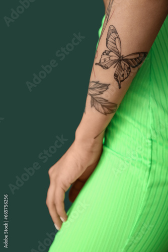 Young woman with tattooed a...