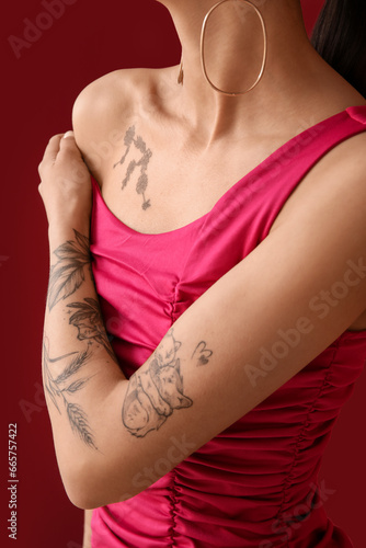 Tattooed young woman on pin...