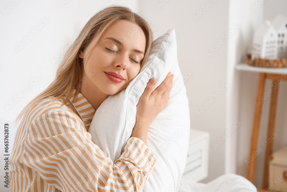 Young woman with pillow in bedroom, closeup Young woman with pillow in bedroom, closeup