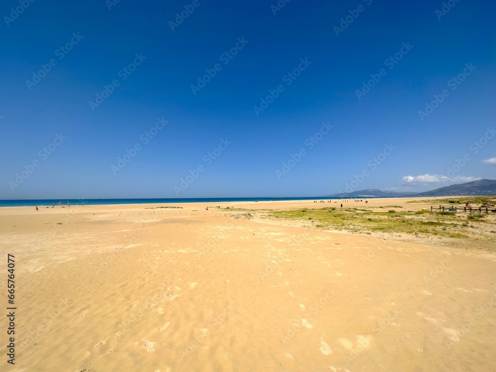 long sandy beach and dunes in Tarifa with a view towards the dune of Valdevaqueros at a beautiful summer day, Playa de los Lances, Playa Santa Catalina, Andalusia, province of Cádiz, Spain