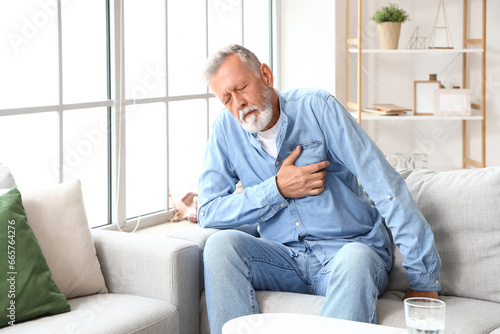 Mature man having heart att...