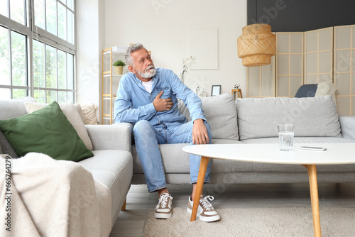 Mature man having heart att...