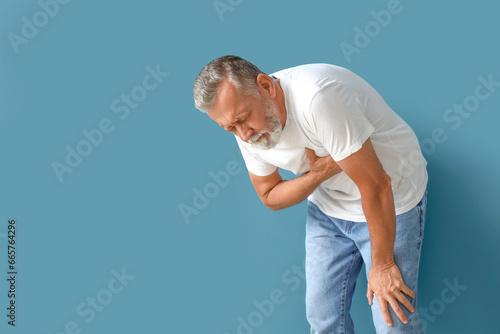 Mature man having heart att...