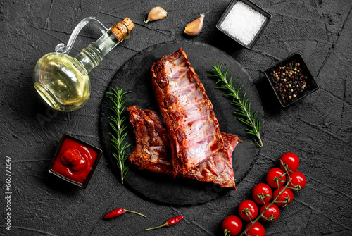 raw marinated pork ribs with spices on stone background with a copy of the space for your text